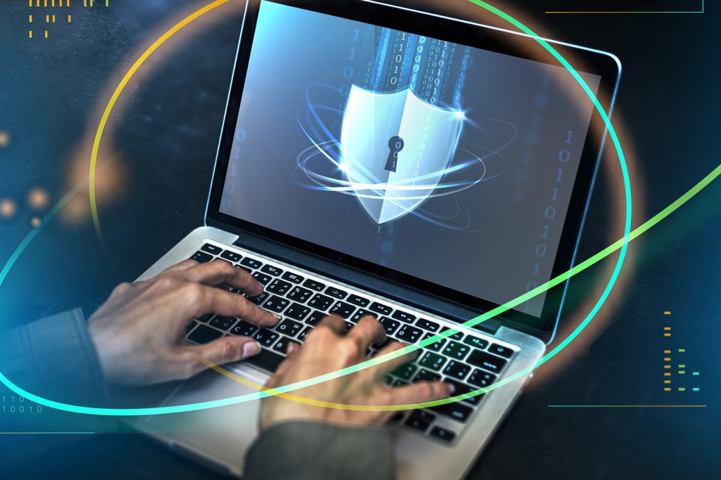 Hacker trying to crack the security code on a laptop